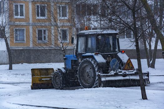 Under snö traktormärken vitryska rengör trottoaren efter snöfall