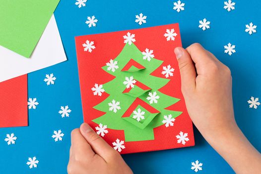 Child makes card with Christmas tree. Original children's art project. DIY concept. Step-by-step photo instructions. Step 10. Final result