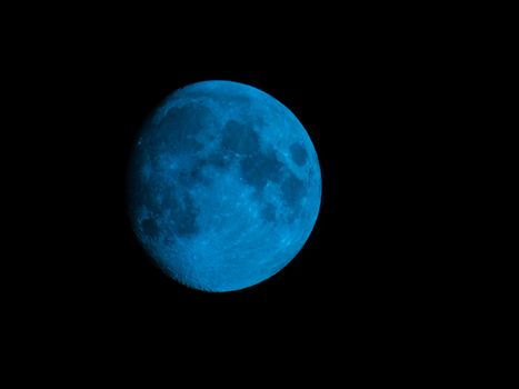 Liguria, Italy - 07/22/2020: Beautiful photography of the moonlight in the different phases with different colours. Black sky and little stars in the background.