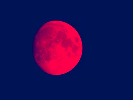 Liguria, Italy - 07/22/2020: Beautiful photography of the moonlight in the different phases with different colours. Black sky and little stars in the background.