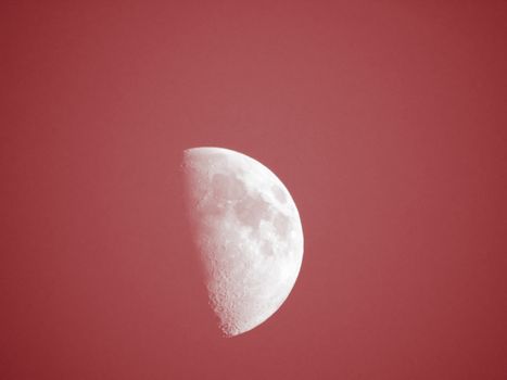 Liguria, Italy - 07/22/2020: Beautiful photography of the moonlight in the different phases with different colours. Black sky and little stars in the background.