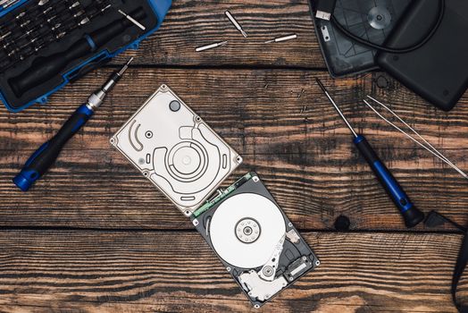 HDD with Screwdriver and Other Tools on Wooden Table