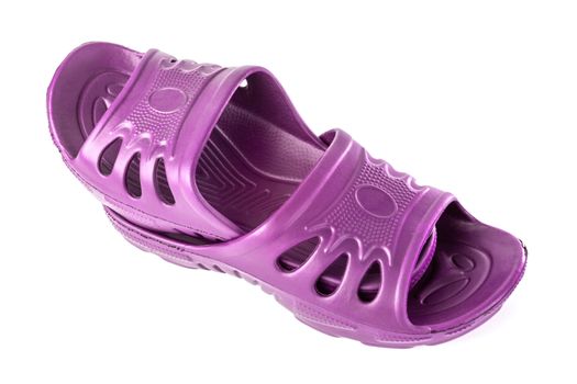 a pair of cheap durable pink rubber slippers one inside other isolated on white background.