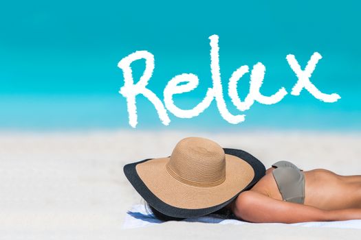 RELAX written on beach background for summer holidays concept. Word above woman tanning lying down sleeping covering her face with hat for uv sun rays protection. Vacation girl relaxing on travel.