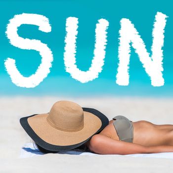 SUN word on beach background for summer holidays concept. Woman tanning lying down sleeping covering her face with hat for uv sun rays protection. Vacation girl relaxing on summer travel.