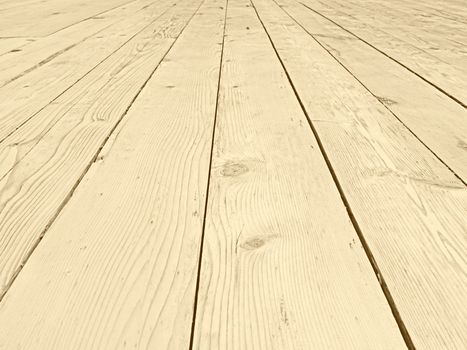 a full frame perspective view of old faded timber planking with a grainy textured surface used for flooring