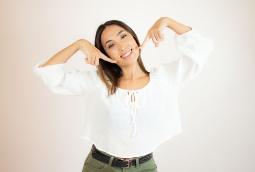 Beautiful young woman in white shirt gesturing