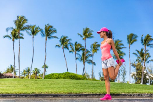 Runner woman stretching leg doing warm-up exercise. Legs stretches exercises before run in summer city park. Healthy lifestyle.