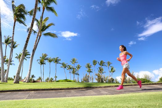 Girl jogging in park living an active summer. Runner woman running on sidewalk, healthy lifestyle.