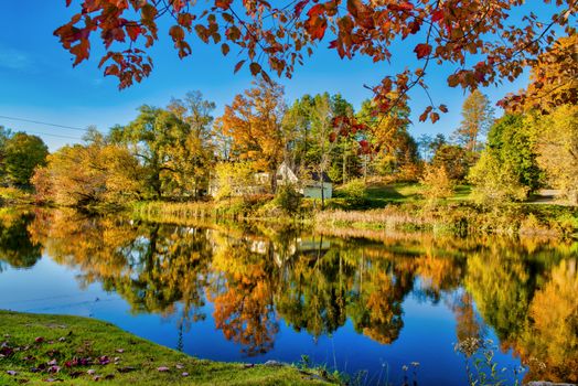 Amazing foliage reflections on a lake. Autumn in New England, USA.