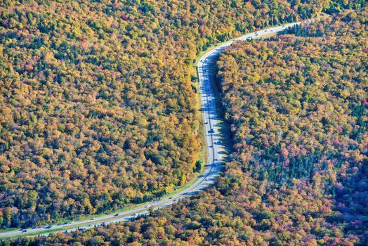 Road across New England countryside in foliage season, USA,