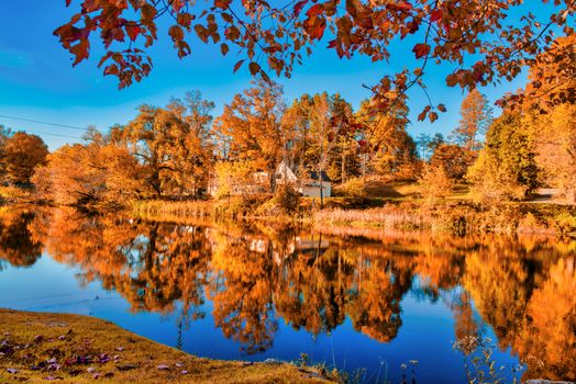 Amazing foliage reflections on a lake. Autumn in New England, USA.