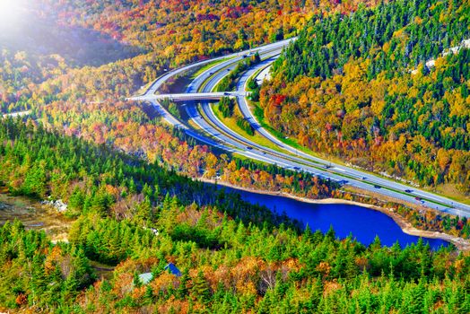 Road across New England countryside in foliage season, USA,