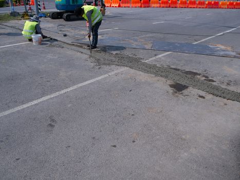 The Builders pouring cement during Upgrade to residential street.