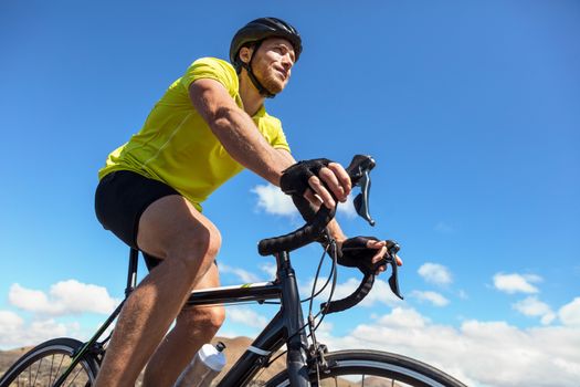 Biking tourist man cycling on road bike traveling in summer doing ecotourism. Sports athlete cyclist riding bicycle. Summer holidays.