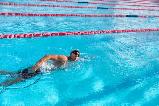 Swim sport athlete swimmer swimming in pool training for race. Professional male watersport adult working out cardio in water at outdoor fitness centre.