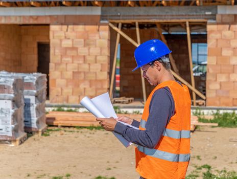 the construction manager inspects the project on the construction of a family house.