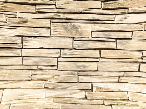 Wall made of light color stone or marble piled up. Light color stone wall background