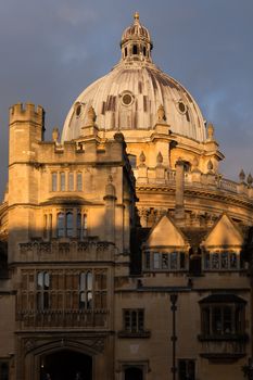 Oxford, Radcliffe Camera UK August 12th 2018 An unusual view of the world famous Radcliffe camera bathed in golden light against a slate grey sky