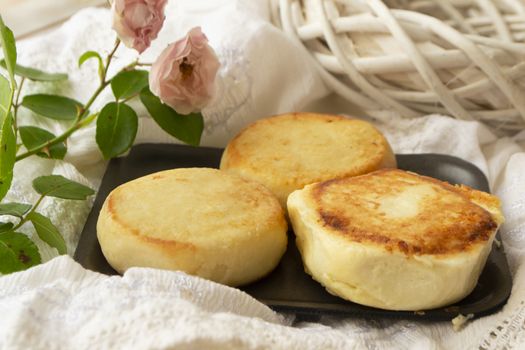 Quark cheese fried pancakes. Traditional russian sweet syrniki from farmer market