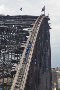Sydney Harbour Bridge with bridge walkers. Very unusual view of the bridge showing a perfect arc with cbd in the backgrounsHigh quality photo