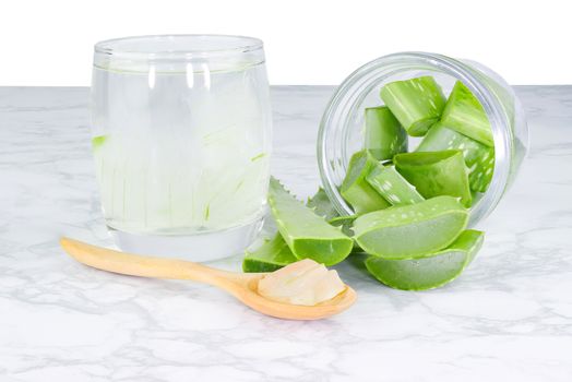 Aloe Vera in Glass and in wooden spoon pile on Cement floor 