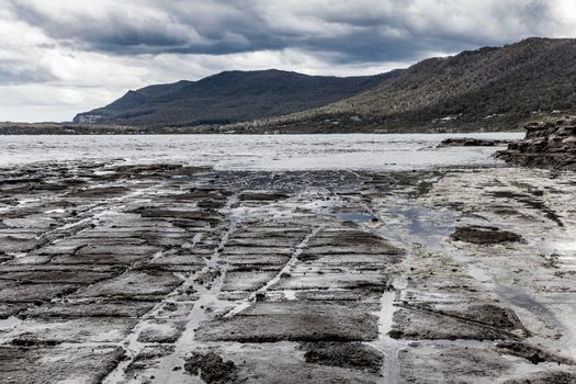Eaglehawk Neck Tessellated Pavement Eaglehawk Neck, Tasmania, Australia. Tessellated pavement is extremely rare, found only in a few places on Earth Dark brooding images with dark grey clouds