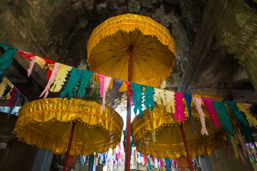 Decorated shrine Angkor Watt, Cambodia, with prayer flags and golden umbrellas. High quality photo