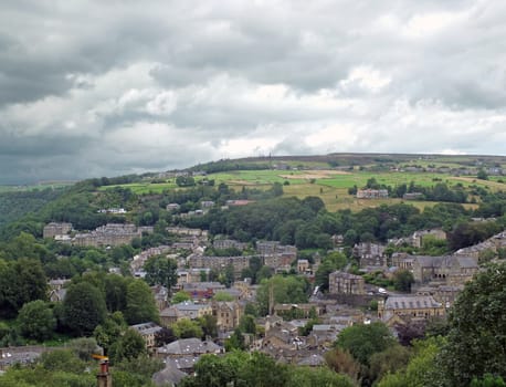 an aerial view of the town of hebden bridge in west yorkshire surrounded by pennine hills and fields