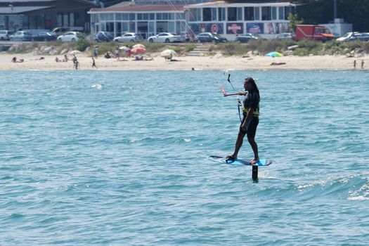 Varna, Bulgaria - July, 19, 2020: a man is kiting the sea against the background of the beachVarna