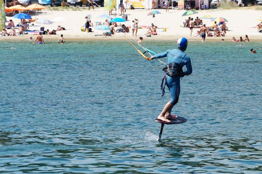 Varna, Bulgaria - July, 19, 2020: a man is kiting the sea against the background of the beachVarna