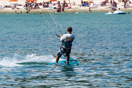 Varna, Bulgaria - July, 19, 2020: a man is kiting the sea against the background of the beachVarna