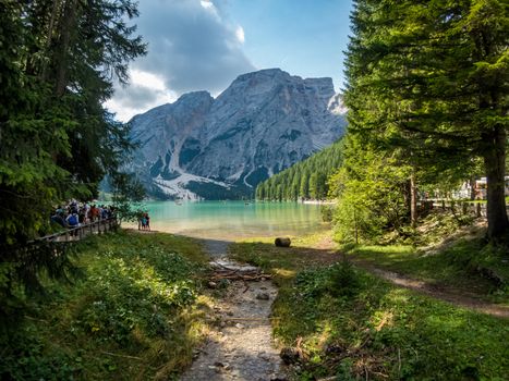 Hiking along the beautiful Braies lake in the Dolomites, South Tyrol