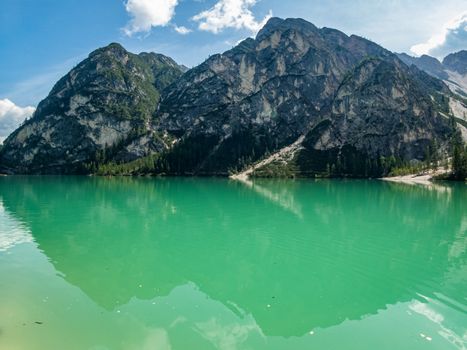 Hiking along the beautiful Braies lake in the Dolomites, South Tyrol