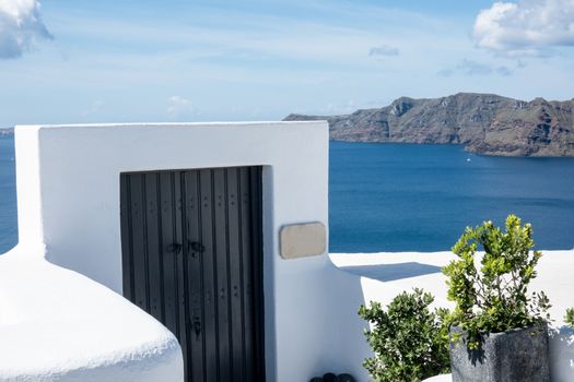 Traditional architecture and wooden door in Oia Village on Santorini Island, Greece.