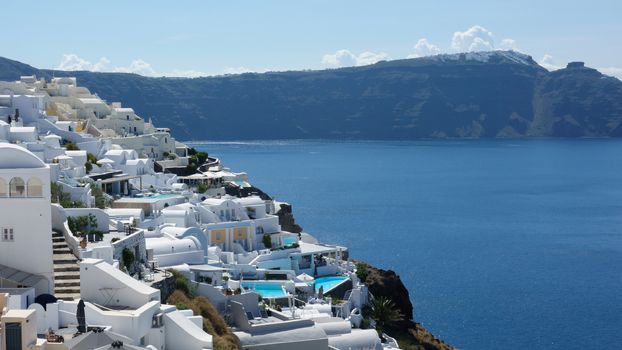 View of the island and whitewashed village of Oia of Santorini, Greece.