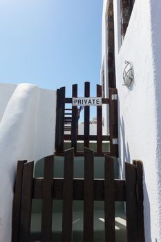 Traditional architecture and wooden door in Oia Village on Santorini Island, Greece.