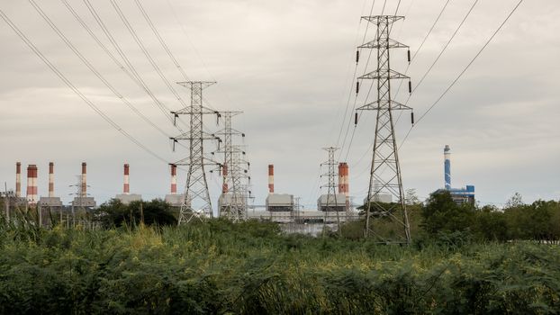 Heavy industrial coal powered electricity plant with pipes.