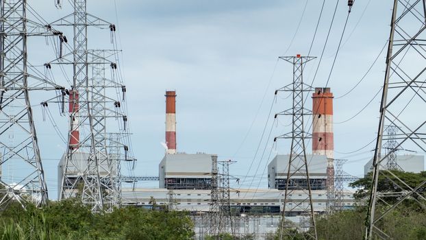 Heavy industrial coal powered electricity plant with pipes.