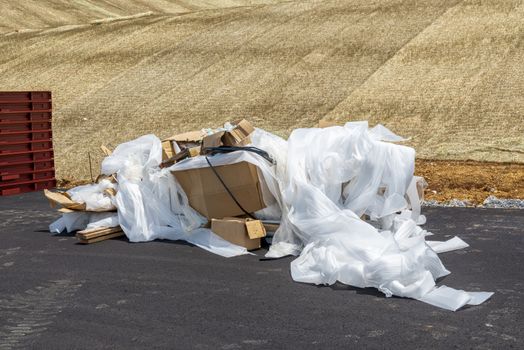 Horizontal shot of a trash pile on a commercial construction site.