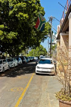 Typical Street with mini van flag of South Africa in Cape Town.