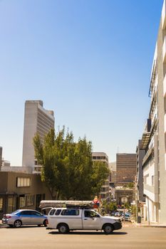 Fast driving white pickup truck in the city of Cape Town.