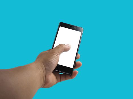 Human hand holding blank screen smart phone isolated on blue background.