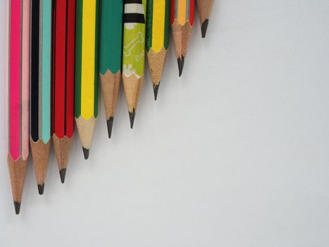 A pencil arranged in a row on a white background.