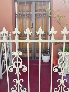 Entrance with fence, wooden door gate in City of Cape Town, South Africa.