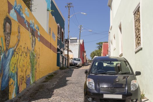 Street with paintings and many colorful houses in the Bo Kaap district in Cape Town, South Africa.