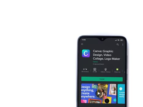 Lod, Israel - July 8, 2020: Canva - Graphic Design app play store page on the display of a black mobile smartphone isolated on white background. Top view flat lay with copy space. 