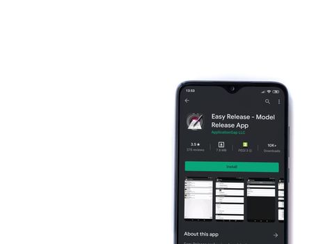 Lod, Israel - July 8, 2020: Easy Release Pro - Model Release app play store page on the display of a black mobile smartphone isolated on white background. Top view flat lay with copy space. 