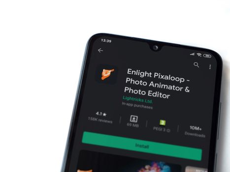Lod, Israel - July 8, 2020: Enlight Pixaloop app play store page on the display of a black mobile smartphone isolated on white background. Top view flat lay with copy space.