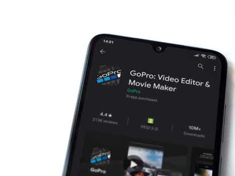 Lod, Israel - July 8, 2020: GoPro - Video Editor & Movie Maker app play store page on the display of a black mobile smartphone isolated on white background. Top view flat lay with copy space.